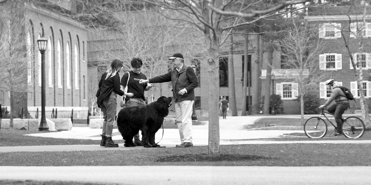 Bowdoin students greet a friendly Brunswick dog resident (who is a very good girl.)