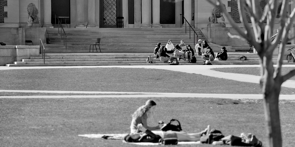 Enjoying the spring weather, a small class gathers on the steps of the Bowdoin College Museum of Art.
