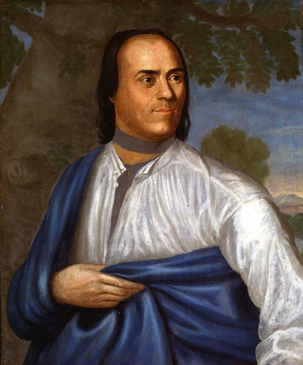 A portrait of a man in a white shirt and blue drapery