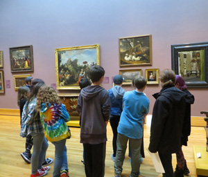 A school group enjoys a tour at the Bowdoin College Museum of Art.
