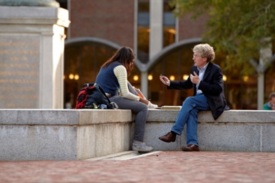 Bowdoin professor and student chatting outside of Hubbard Hall.