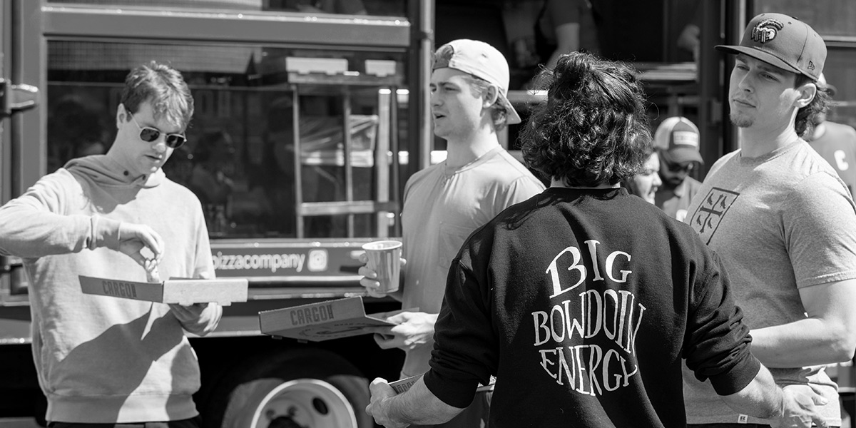 Bowdoin students enjoy a pizza truck at the spring celebration on the Quad.