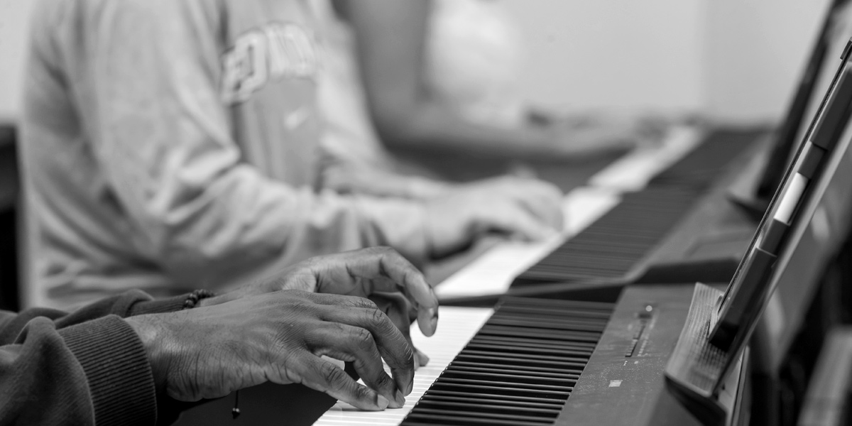 Bowdoin students working together in the introductory piano course.