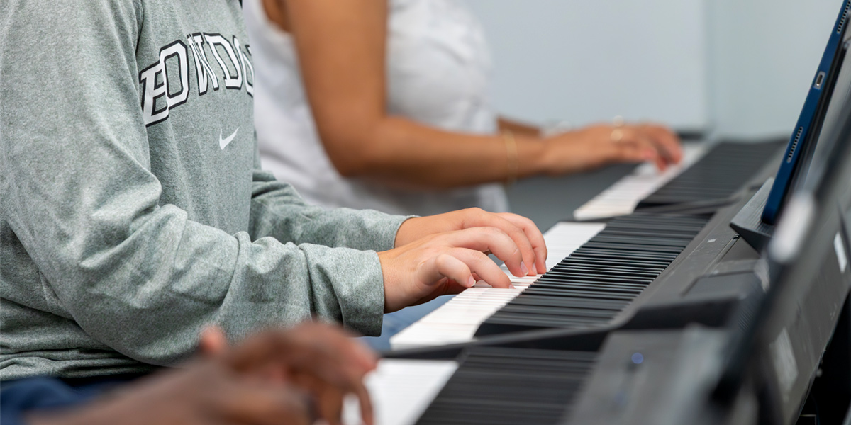 Bowdoin students working together in the introductory piano course.