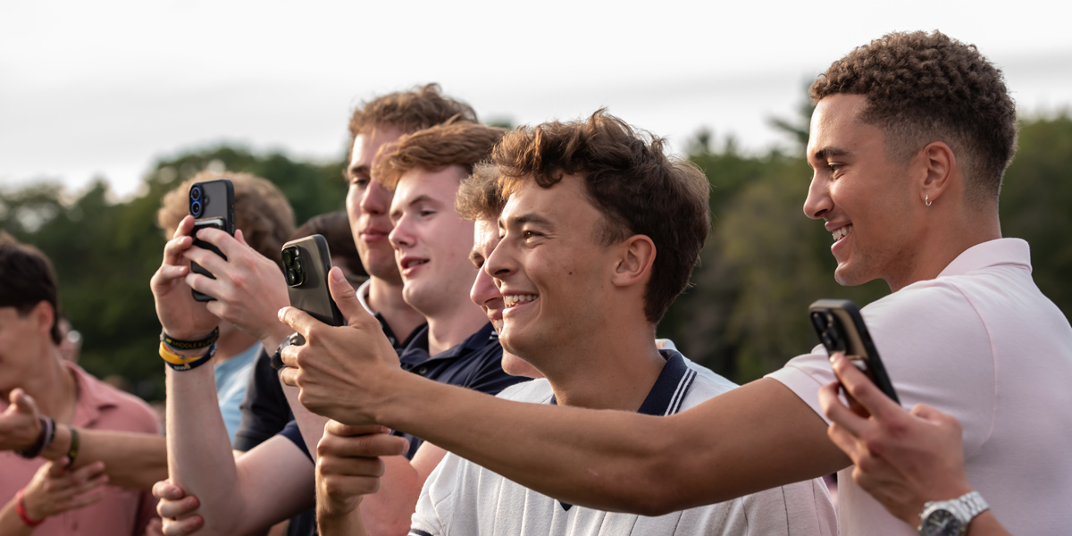 Bowdoin students take photos at the Fall Lobster Bake, an annual tradition.