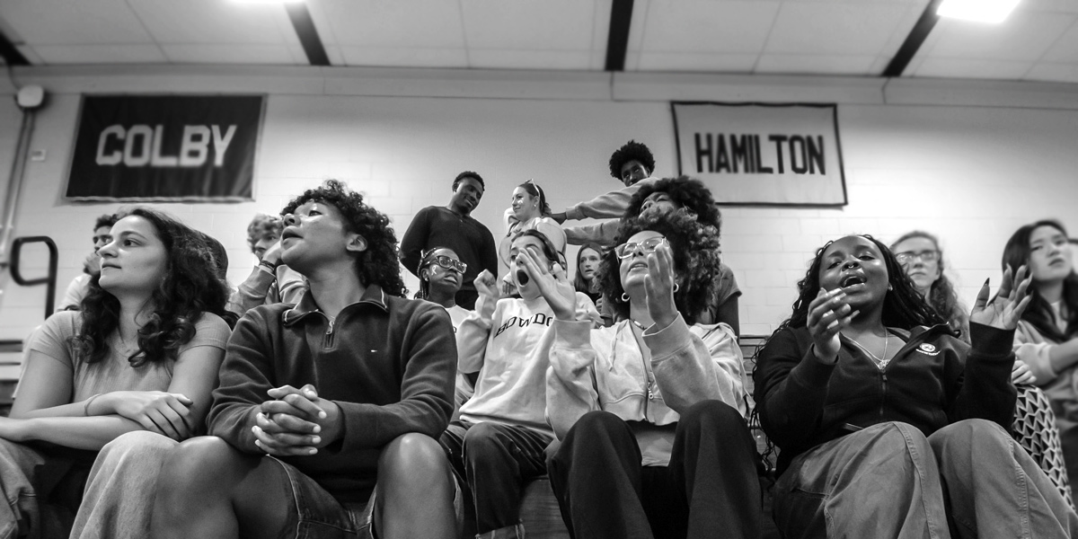 Bowdoin students and alums cheer on the Polar Bear volleyball team.