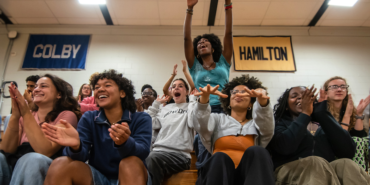 Bowdoin students and alums cheer on the Polar Bear volleyball team.