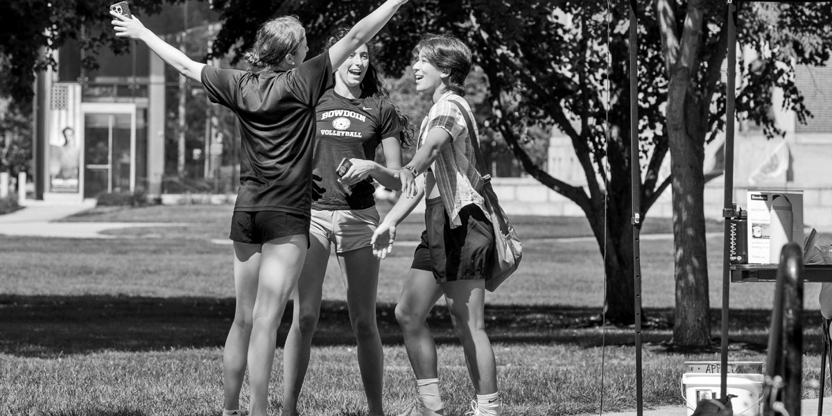 Bowdoin students greet one another upon their return to campus for the fall semester.