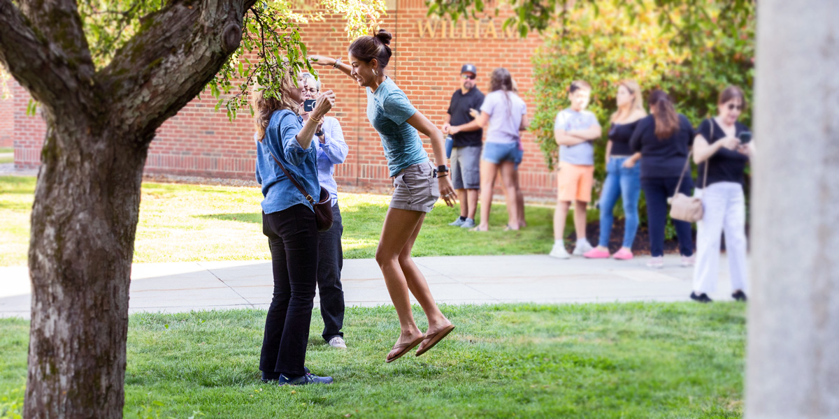 A Bowdoin family says goodbye on Arrival Day with a jumping hug.