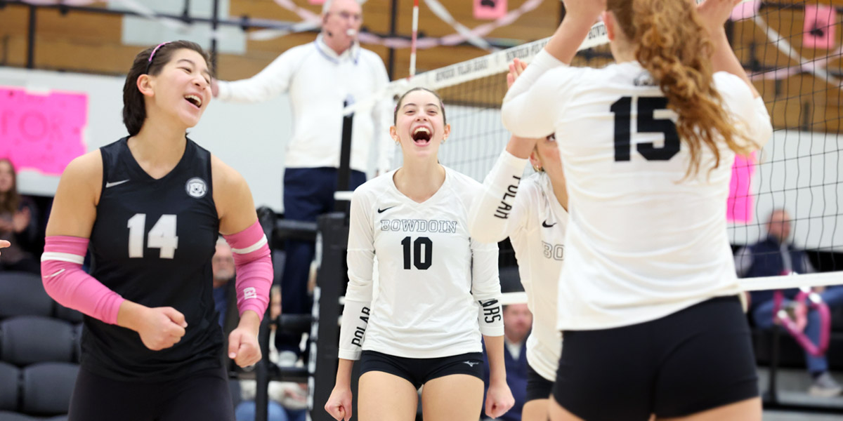 Bowdoin volleyball celebrates at home.