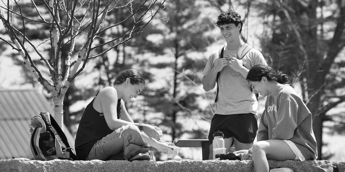 Bowdoin students enjoy the sunshine in the College's odeon.