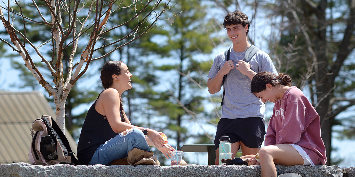 Bowdoin students enjoy the sunshine in the College's odeon.