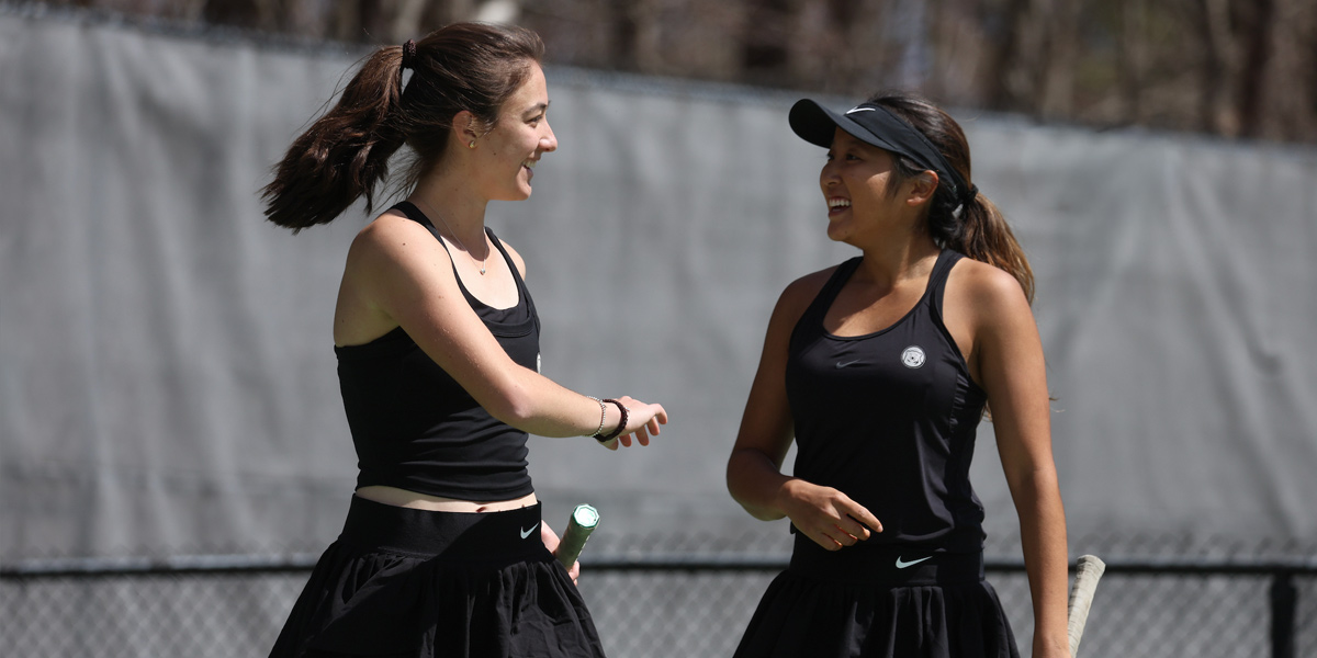 Bowdoin women's tennis celebrates a win at home.