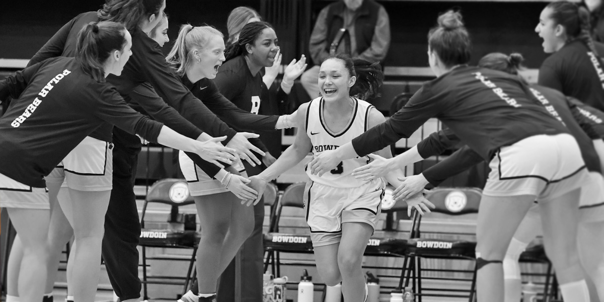 Bowdoin women's basketball gets the home crowd excited.