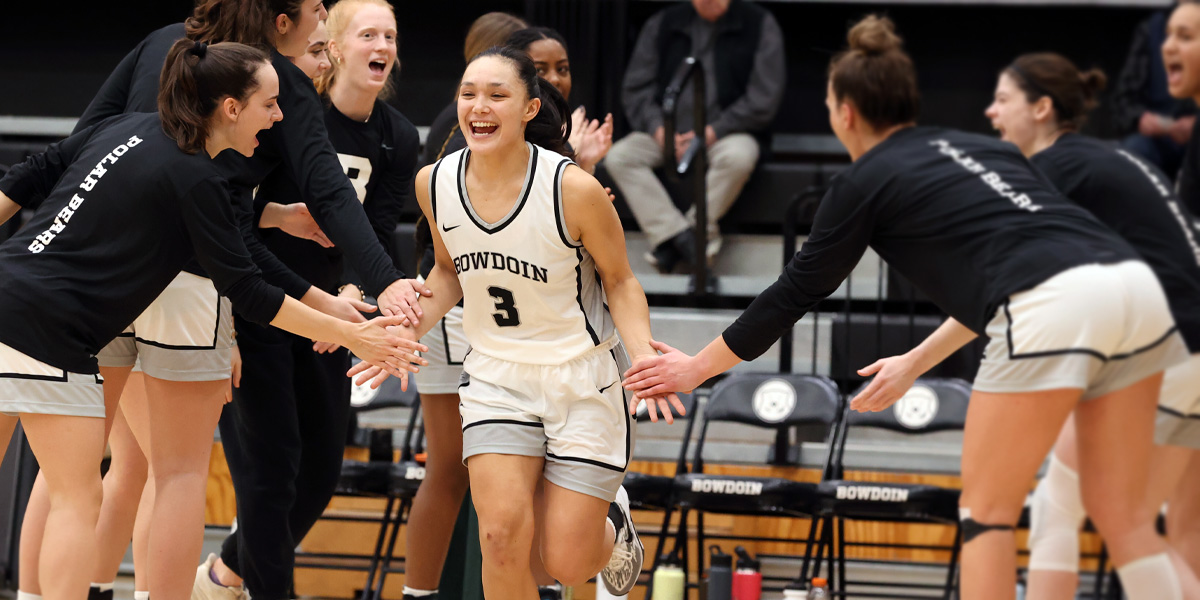 Bowdoin women's basketball gets the home crowd excited.