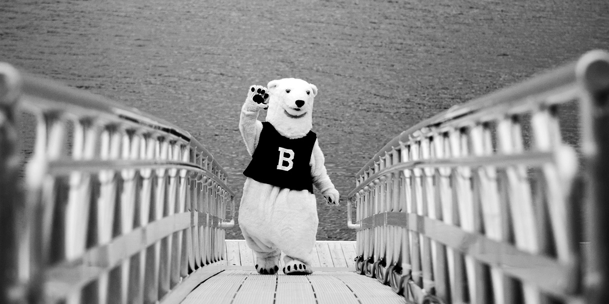 The Bowdoin Polar Bear waves from the dock at the Schiller Coastal Studies Center.
