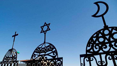 A photograph of the symbols of Judaism, Islam, and Christianity