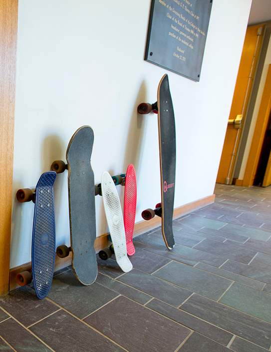 Skateboards leaning up against a wall