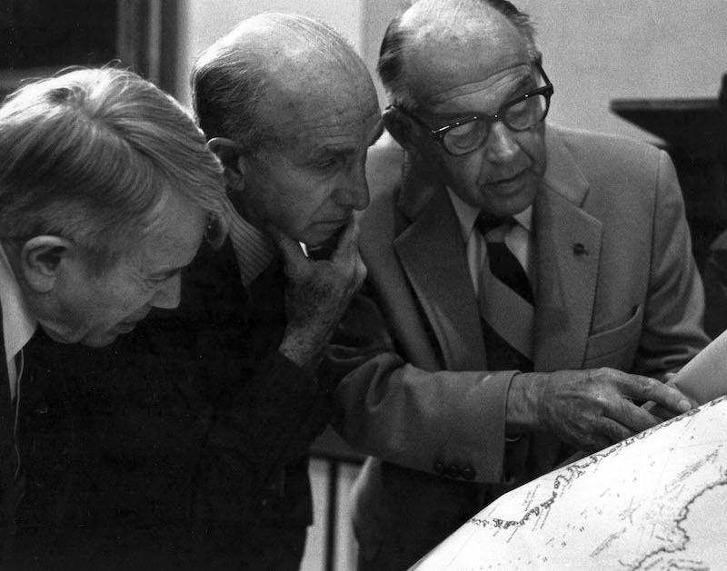 Three men looking at a map