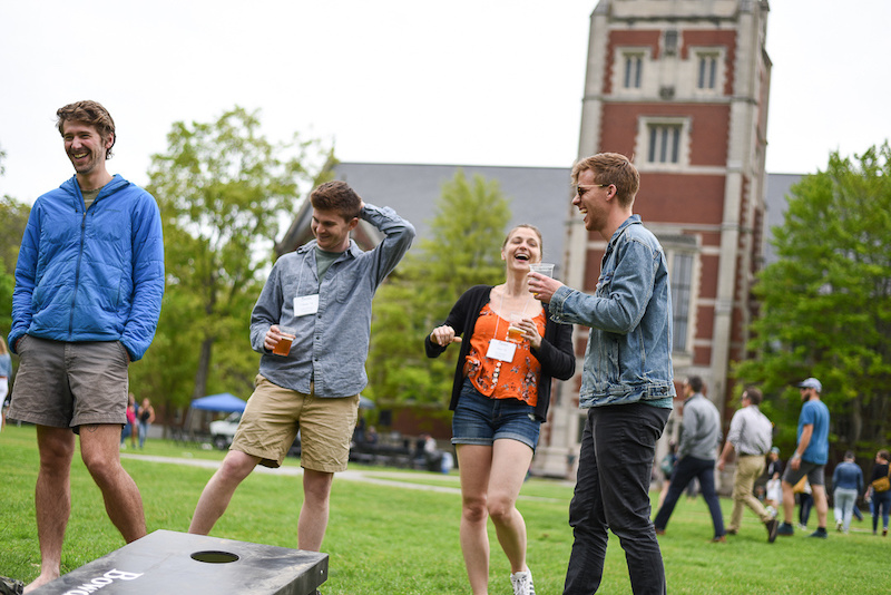 Group of people laughing on campus
