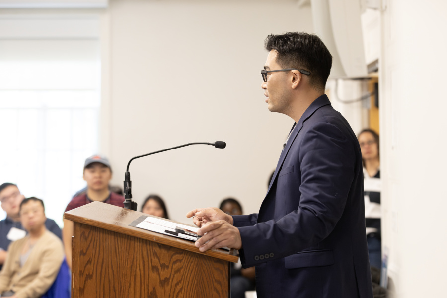 Hae-Min Gil speaking at a podium