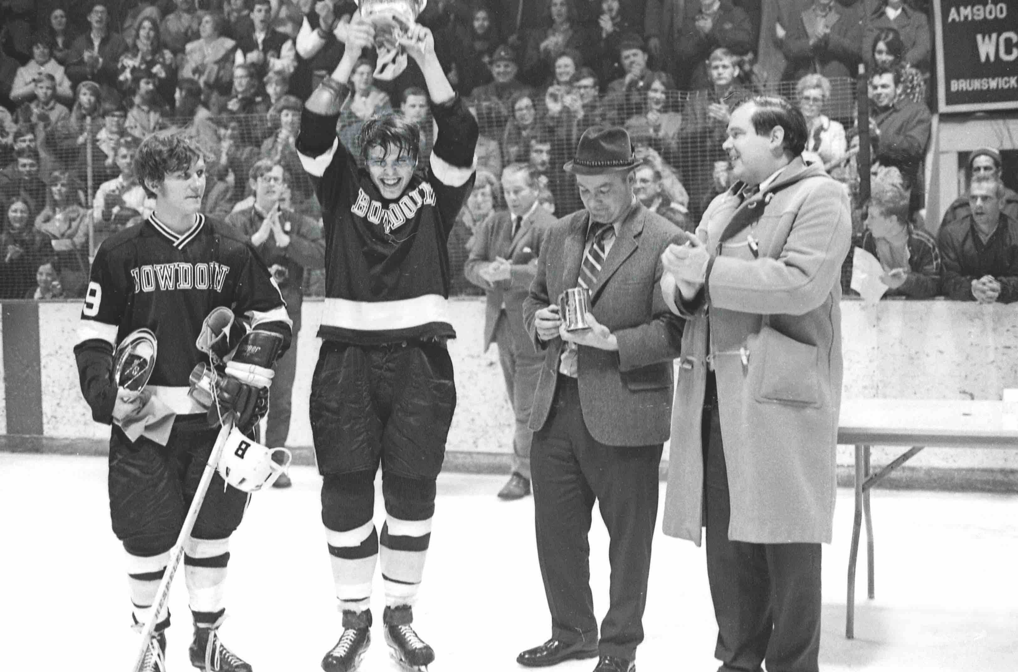 Ed Good holding up the ECAC trophy