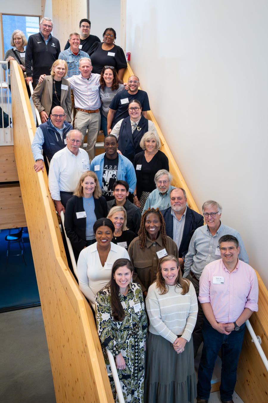 Alumni Council members gather for a photo on the stairs in Barry Mills Hall: Alumni Council members, from the top row: Cheryl Coffin '75, Tom Sheehy '69, P'93, '96, Rich Miller '96, Sean Mahoney '86, Adriennie Hatten '90, Katherine Griem '78, P'13, '17, Nick Stoneman '83, P '14, '23, Jen Ryan '99 (president), Edgardo Sepulveda '15, Jeremy Segal '92, Amber Orosco '19, Don Westfall '72, Fhiwa Ndou '13, Beth C. Richardson '79, Sarah Nadelhoffer '81, Uriel López-Serrano '20, Kent Spriggs '61, Jenn Graham Billings '86, Dan Olds (Alumni Relations), Mariana Centeno '14, Sherrone Torres '12, Erik Jorgensen '87, Maxine J. Symes '10, Jenna Goldman '03, and Mark Lucci '04