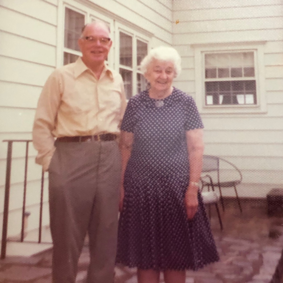 Bill and Irma standing in front of the farmhouse