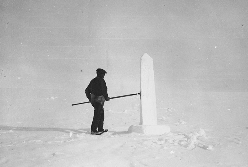 <p><b>Early Work</b> </p>   One of the crew created a model of the monument in snow, so all could see what it would look like. Stone masons from Newfoundland used local rock to build it. Marie described the monument: <br /> The form of the memorial was simplicity itself—a sixty foot shaft of native stone, quarried at the spot, and topped by a cap of non-tarnishable metal similar to that which crowns the Empire State and Chrysler buildings. In shape, the monument was to be triangular, with one point directed towards the north and on each of the other sides, marble letter “P’s” were to be set in, standing for 'Peary' and the 'Pole.' Marie Peary Stafford<br /> <br />  Unknown photographer, Snow model of the Peary Monument; mason checking stone, Cape York, Greenland, 1932. Ink jet prints from black and white photographs. Robert Abram Bartlett papers, George J. Mitchell Department of Special Collections & Archives, Bowdoin College Library. 