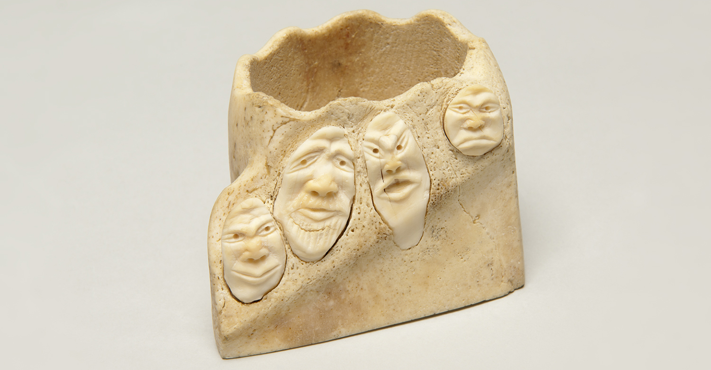 Faces carved on walrus teeth.  Unidentified Inuit artist, Kangaamiut, ca. 1940. Ivory. Gift in memory of Ankar Baregard. Photo by Dean Abramson.