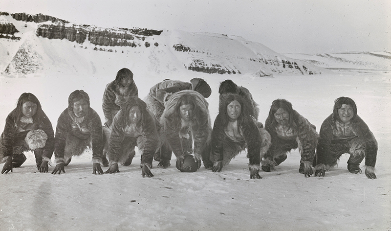 Inuit men playing rugby.