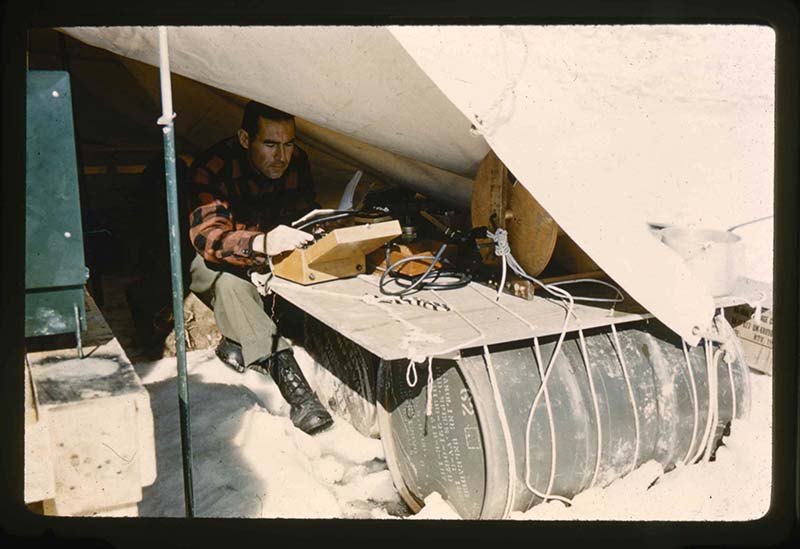 Stanley Needleman, Dan Krinsley Reading Thermistor Cable Meter and Measurements, Centrum Lake, northeast Greenland, May 31, 1960. 35mm slide. Gift of Stanley Needleman.