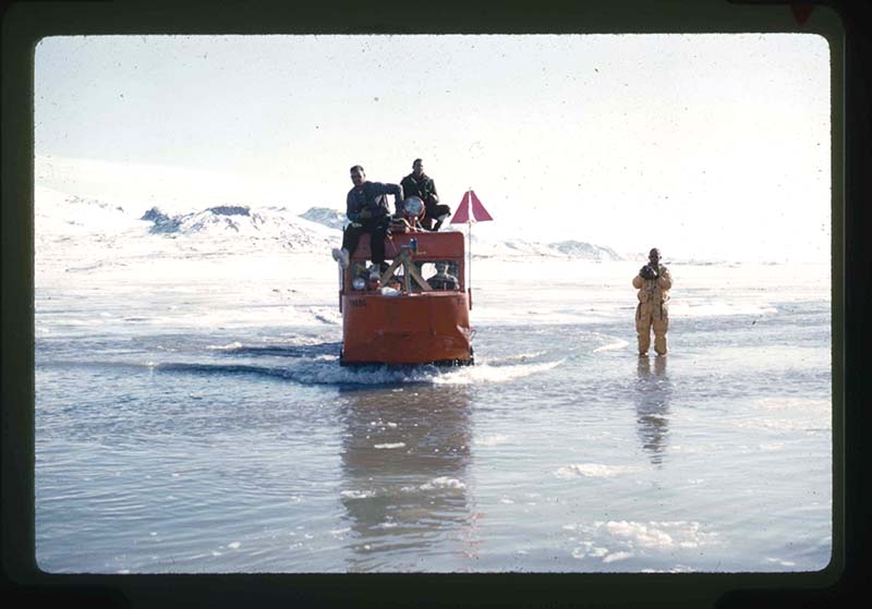 Stanley Needleman, Tracked Weasel Transporting Personnel and Equipment through Water and Moat, Centrum Lake, northeast Greenland, June 1960. 35mm slide. Gift of Stanley Needleman.