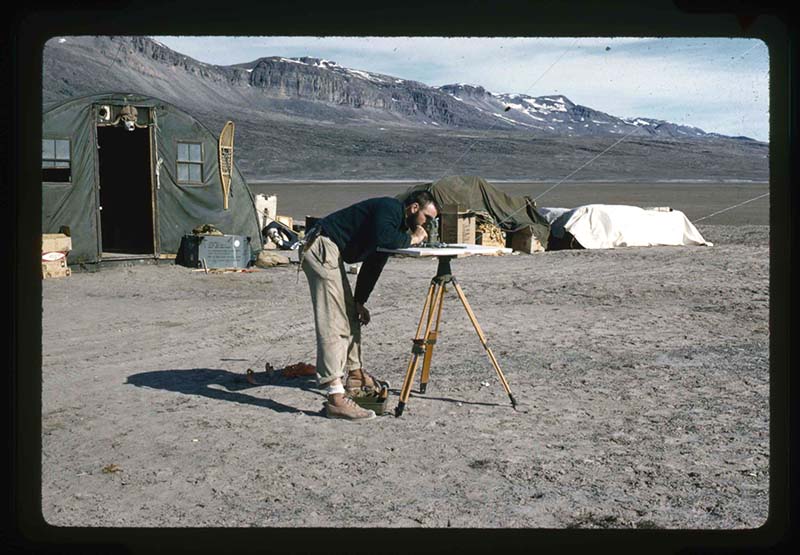 Stanley Needleman, Kinsellar, Surveyor, is Checking Base Line of Airstrip from Centrum Lake Base, Centrum Lake, northeast Greenland, July 1960. 35mm slide. Gift of Stanley Needleman.
