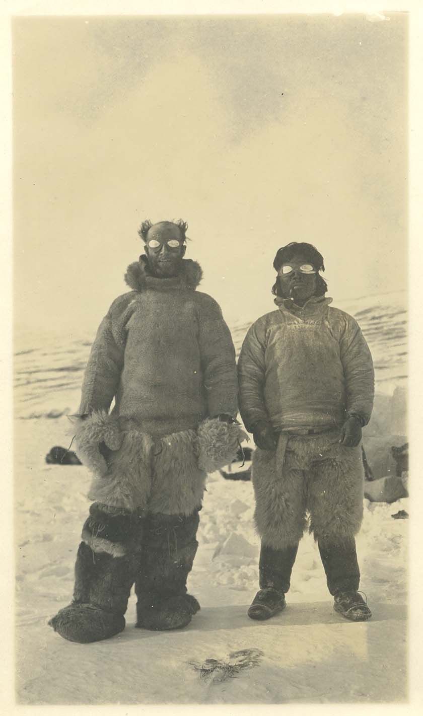 two men in full winter gear, sepia colored photo