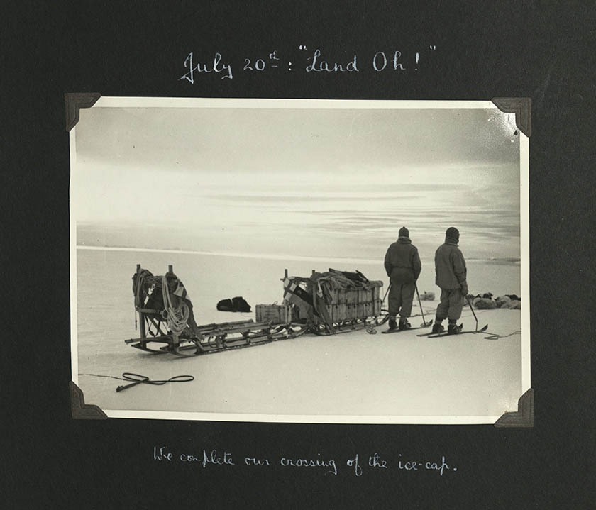 old black and white photo of dog sled and two drivers