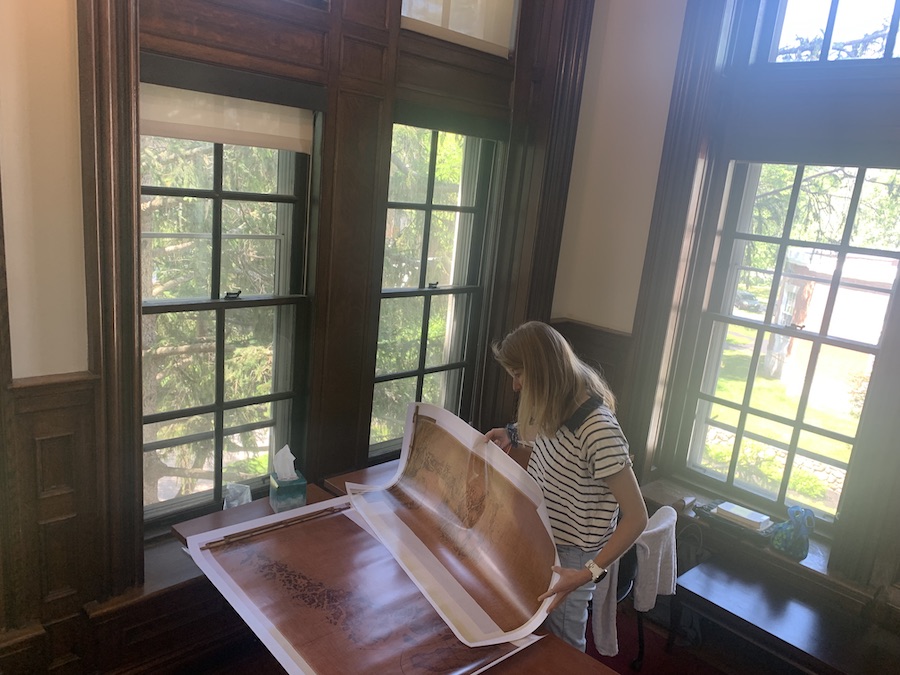 Gibbons Fellow Aggie Macy ’24 looks through archival maps of Greenland
