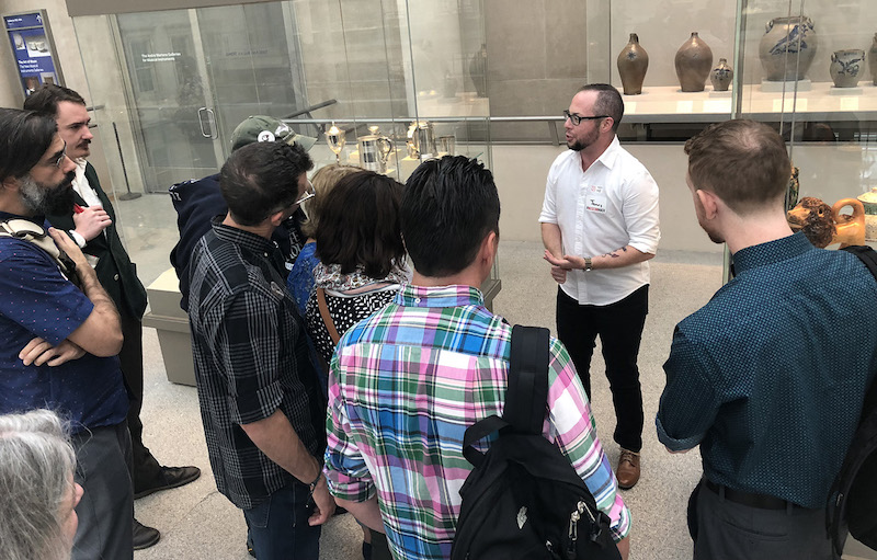 presenter in the museum speaking to group of students