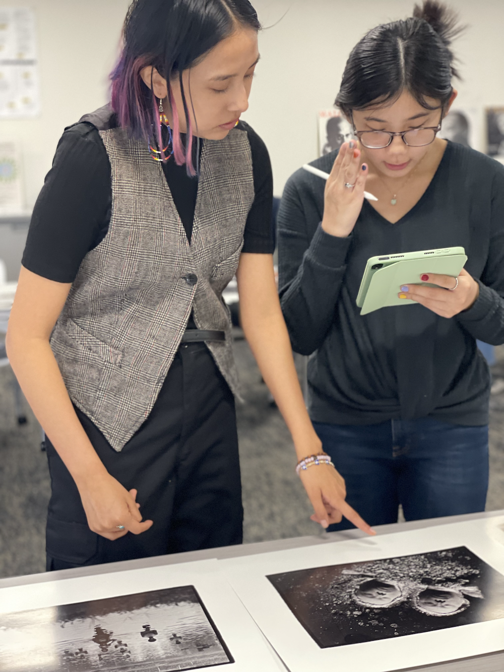 Two students looking at photo