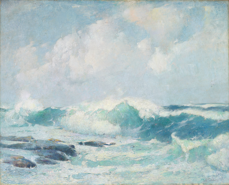 waves breaking on rocks at left of image