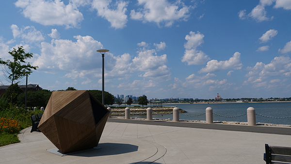 a wooden sculpture by the water in Boston