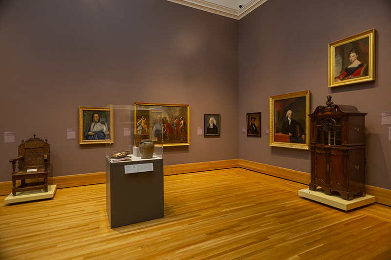 a photo of paintings on a wall of a museum
