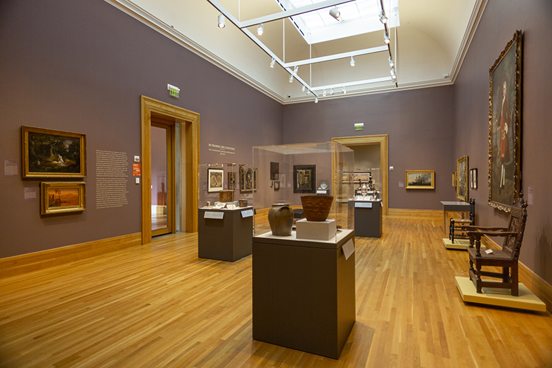 a photo of paintings on a wall of a museum