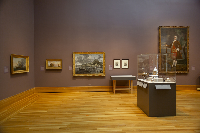 a photo of paintings on a wall of a museum