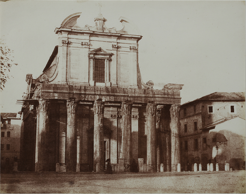 an old photograph of a temple/building with columns