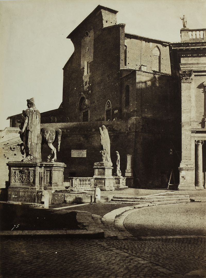 A sepia photograph showing statues in front of a building