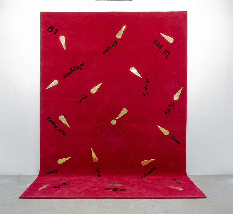 A large red carpet with adornments in brass