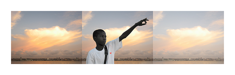 image of a young man in a white t-shirt, pointing towards the right, against a sky of orange clouds