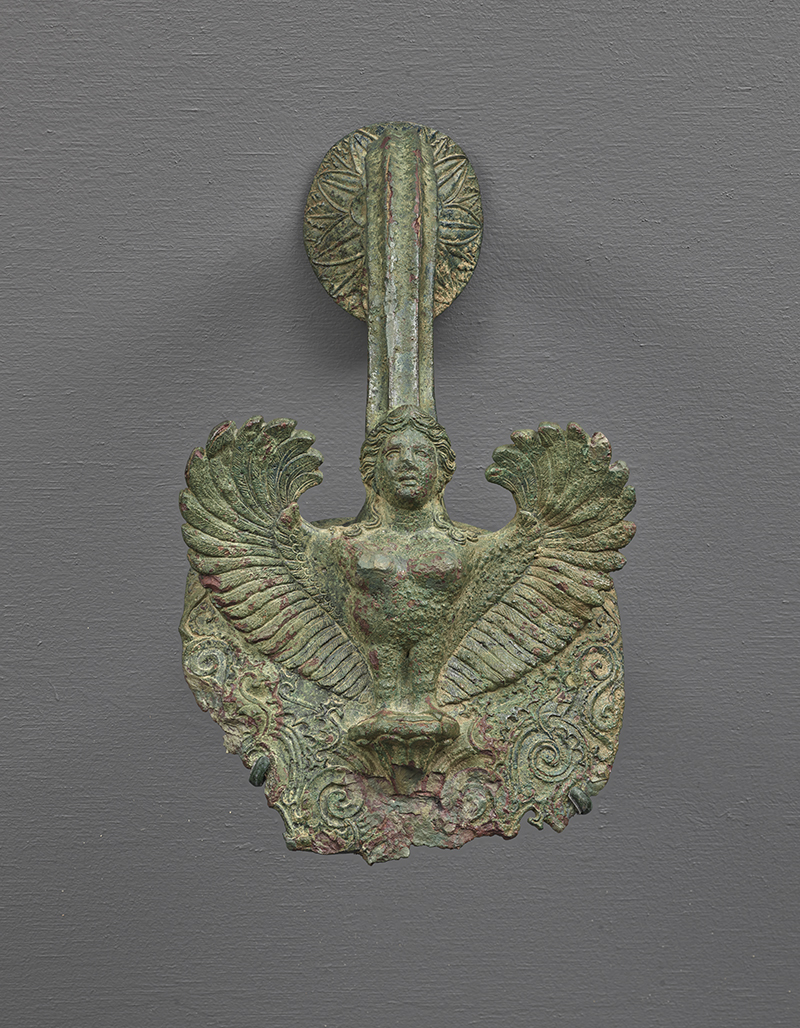 An ancient bronze handle in the form of a "siren." a mythological figure