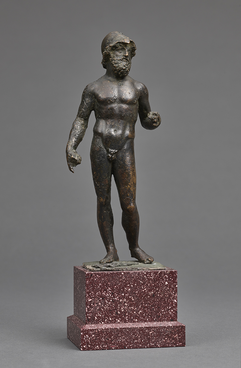 An ancient sculpture of a nude male warrior